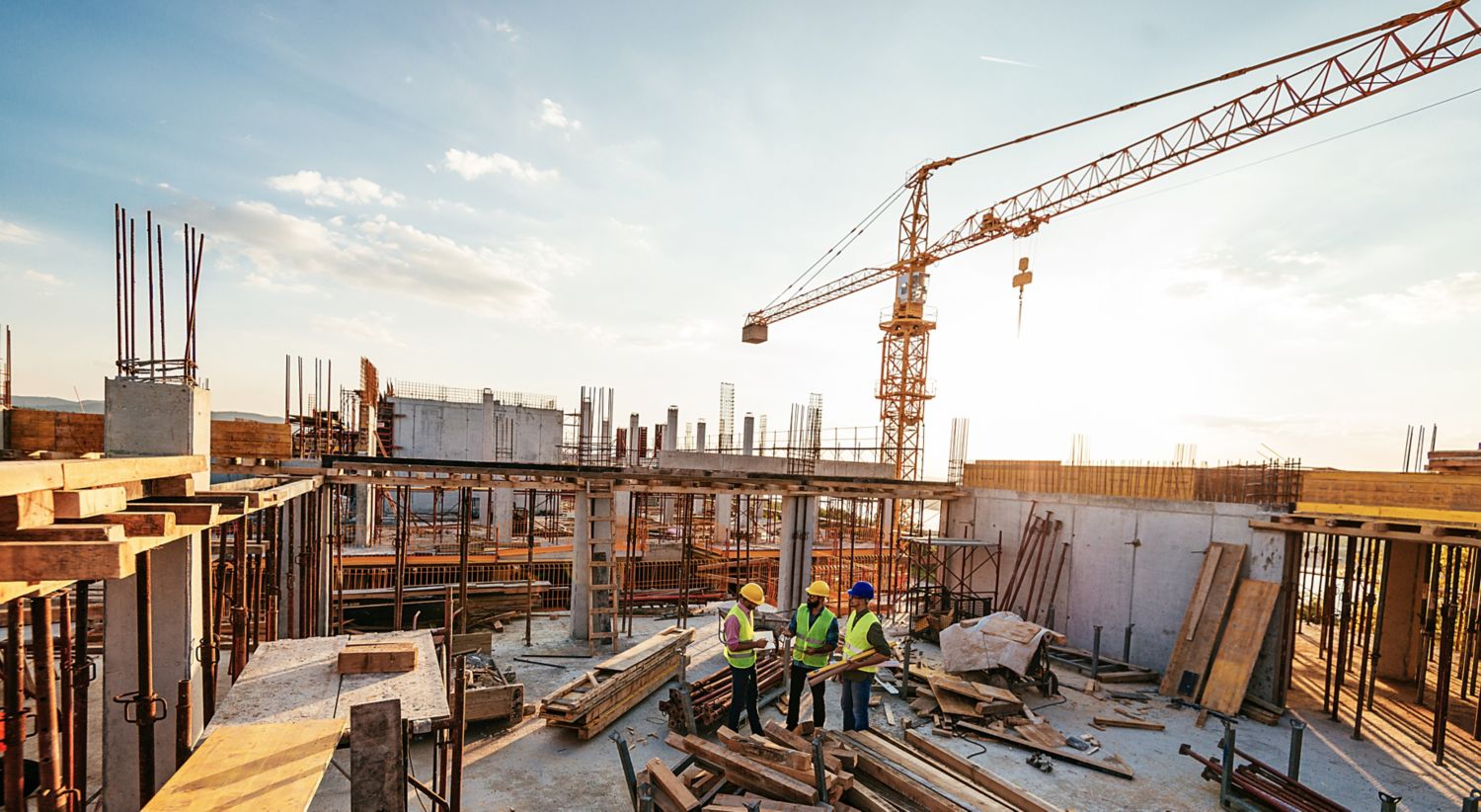 Image of building site with three project managers