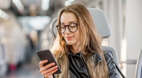 Young woman sitting looking at her mobile phone