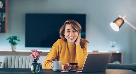 Woman sitting at a computer and smiling