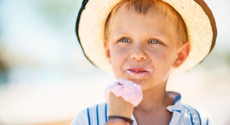 Boy with straw hat eating ice cream