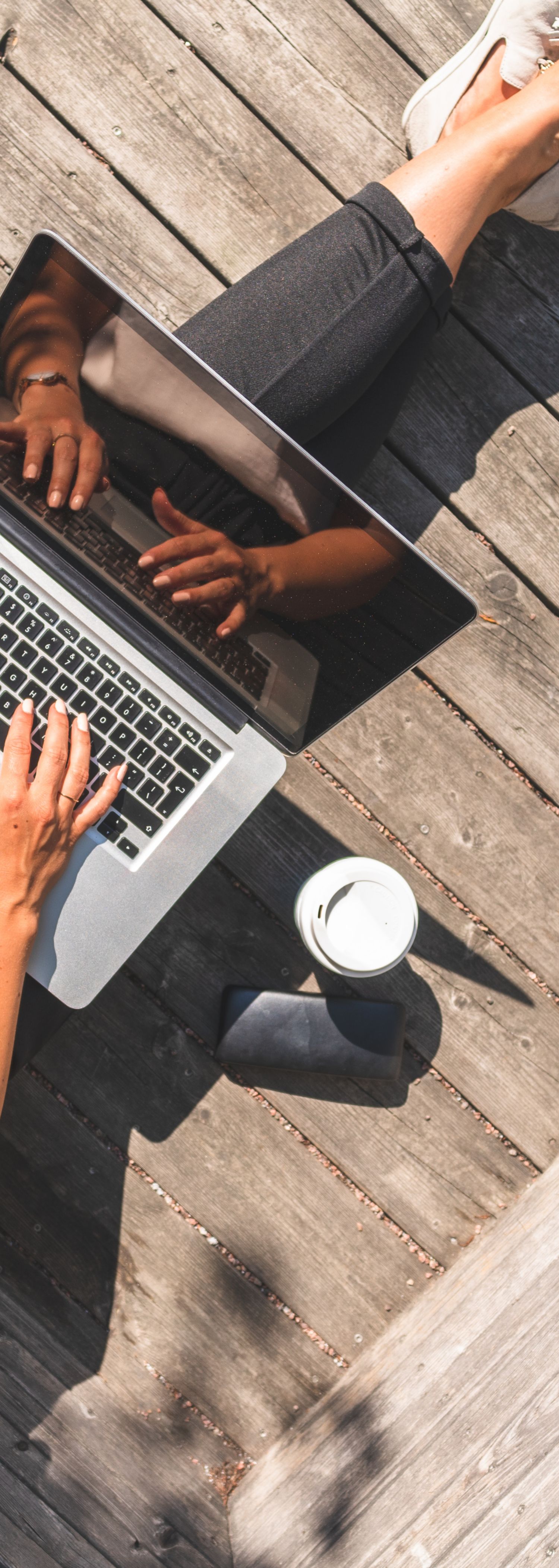 Woman with laptop working on the veranda