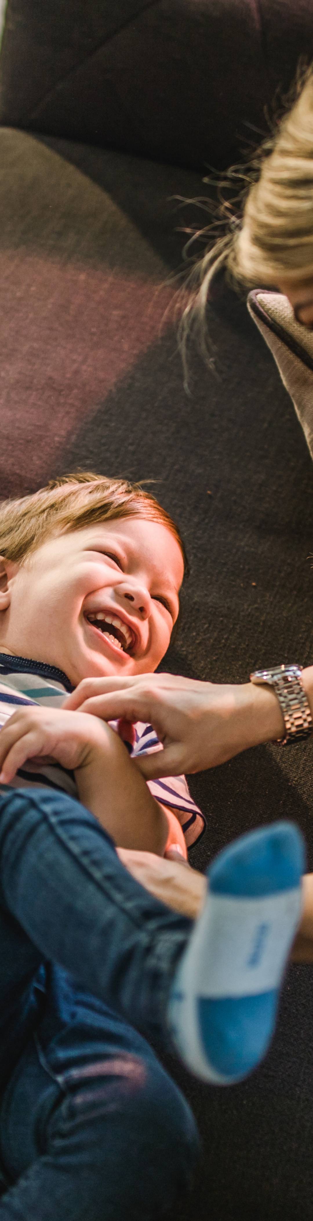 Parent tickling a child. Photo.