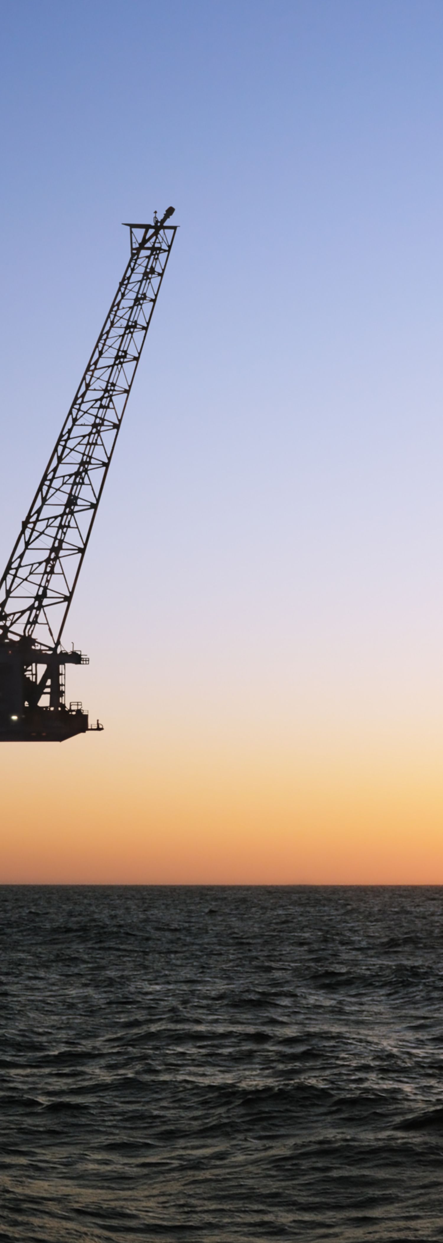 Oil rig at sunset. Photo.