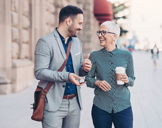 Picture of a man and a woman smiling together out on the street