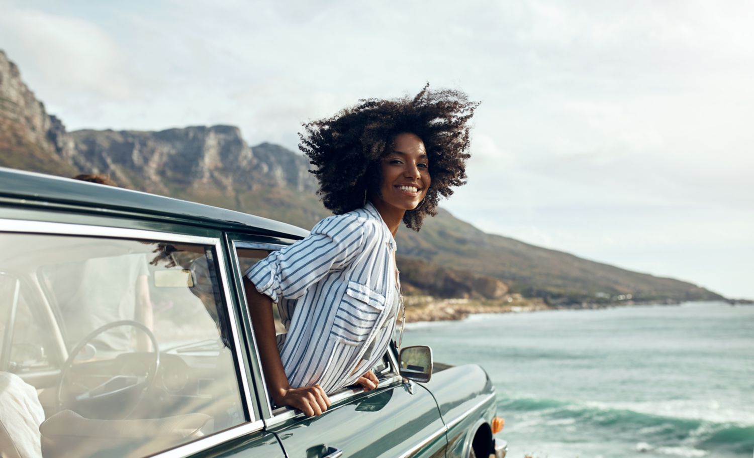 Woman leaning out of a car