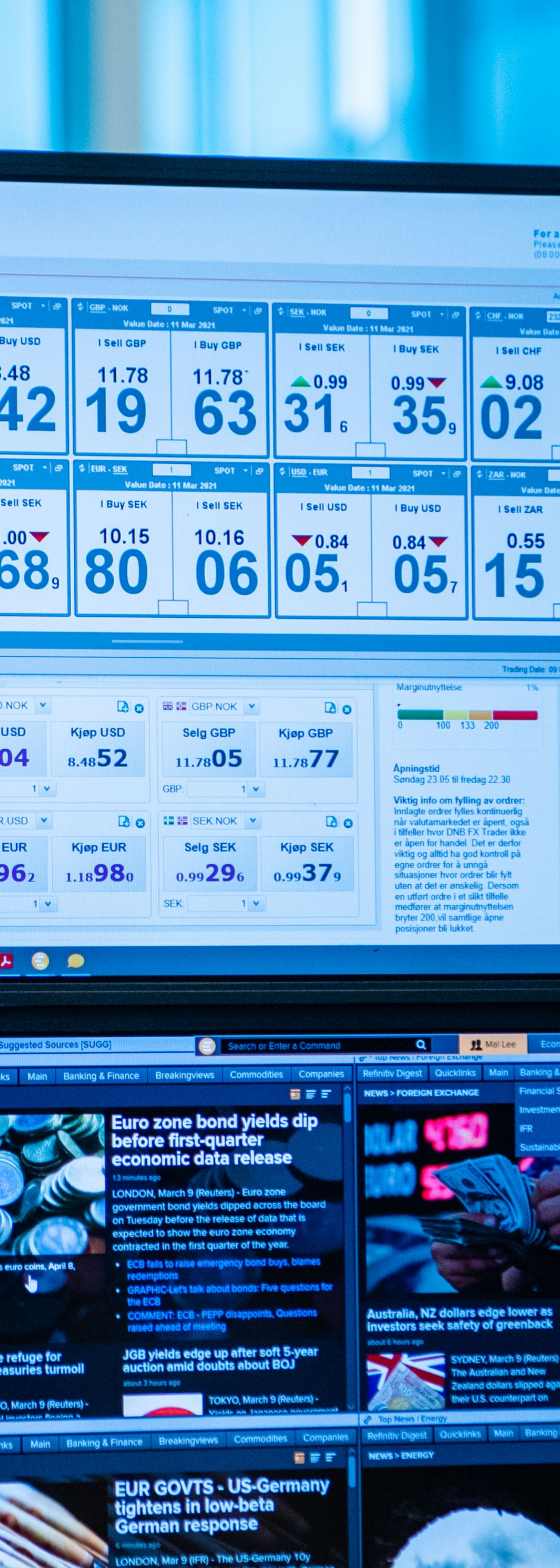 Young woman looking at foreign exchange rates on a screen
