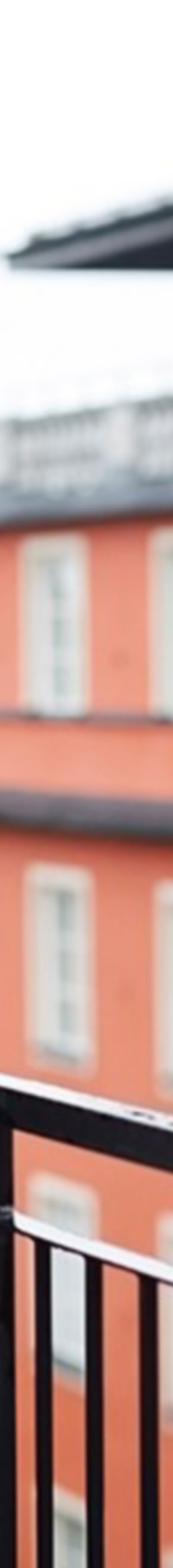 Young man on a balcony in a block.