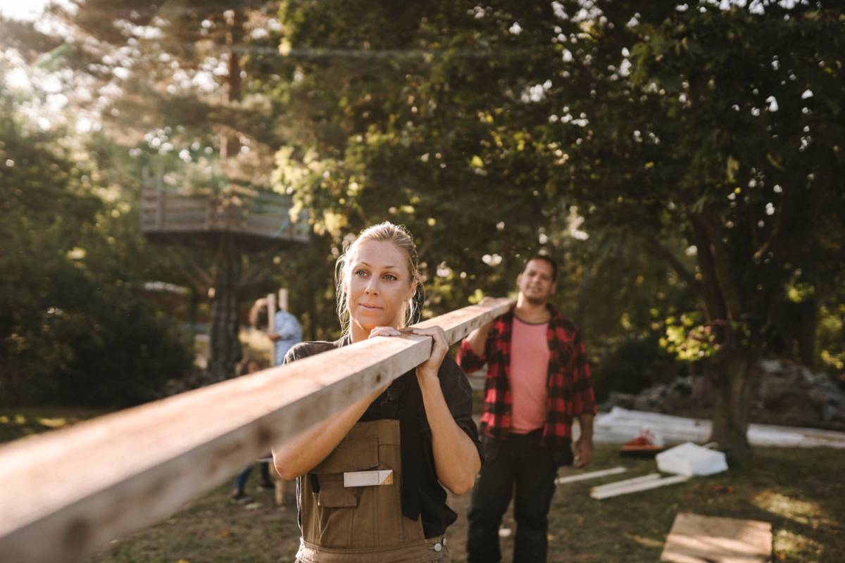 Couple carrying a plank