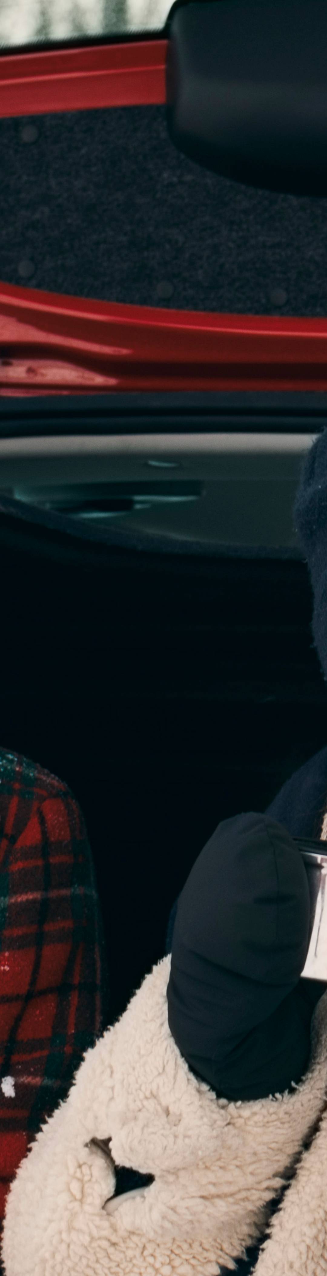 Couple sitting in the boot of a car