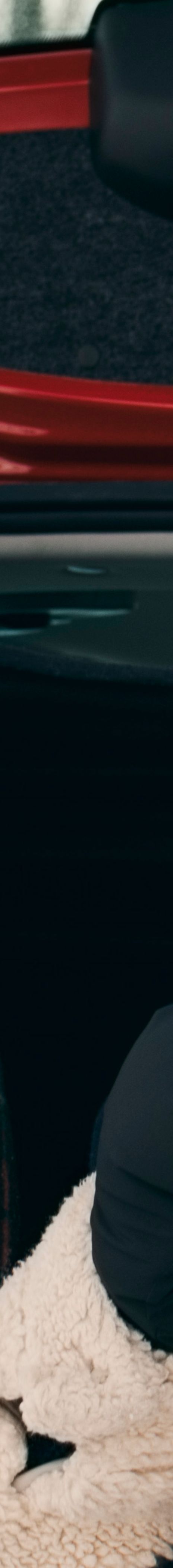 Couple sitting in the boot of a car