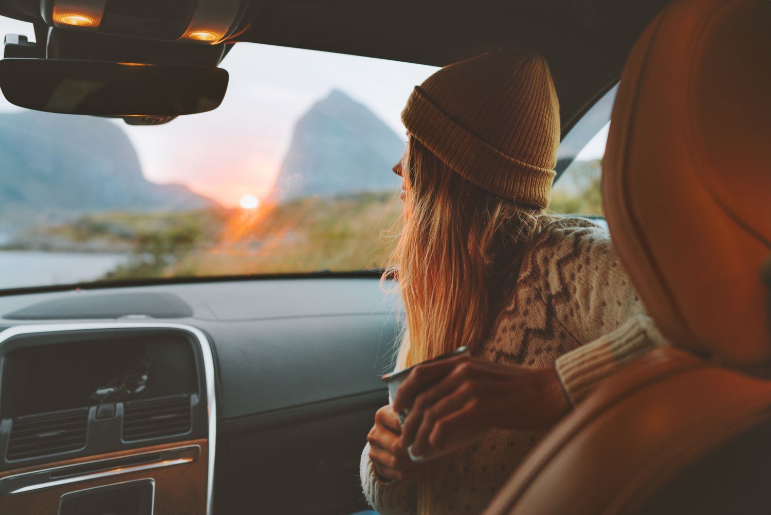 Woman in car at sunset