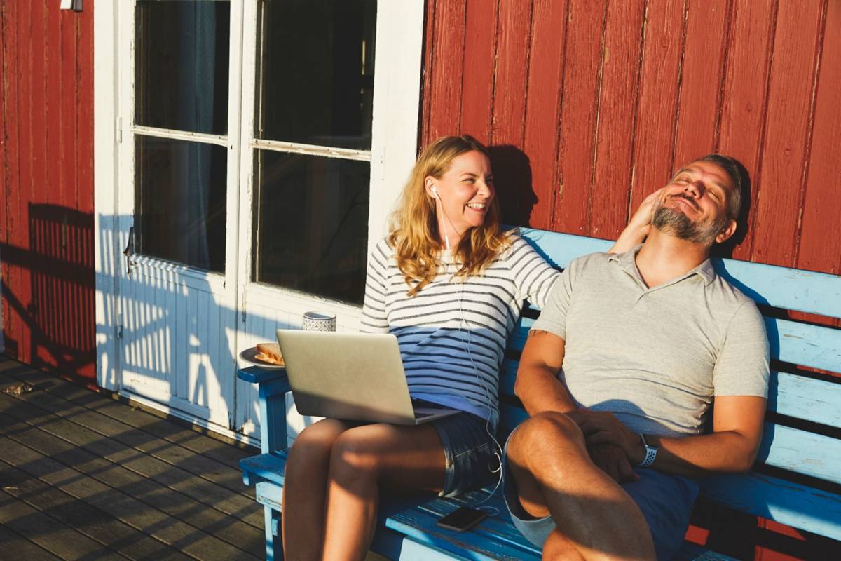 Man and woman on bench in the sun