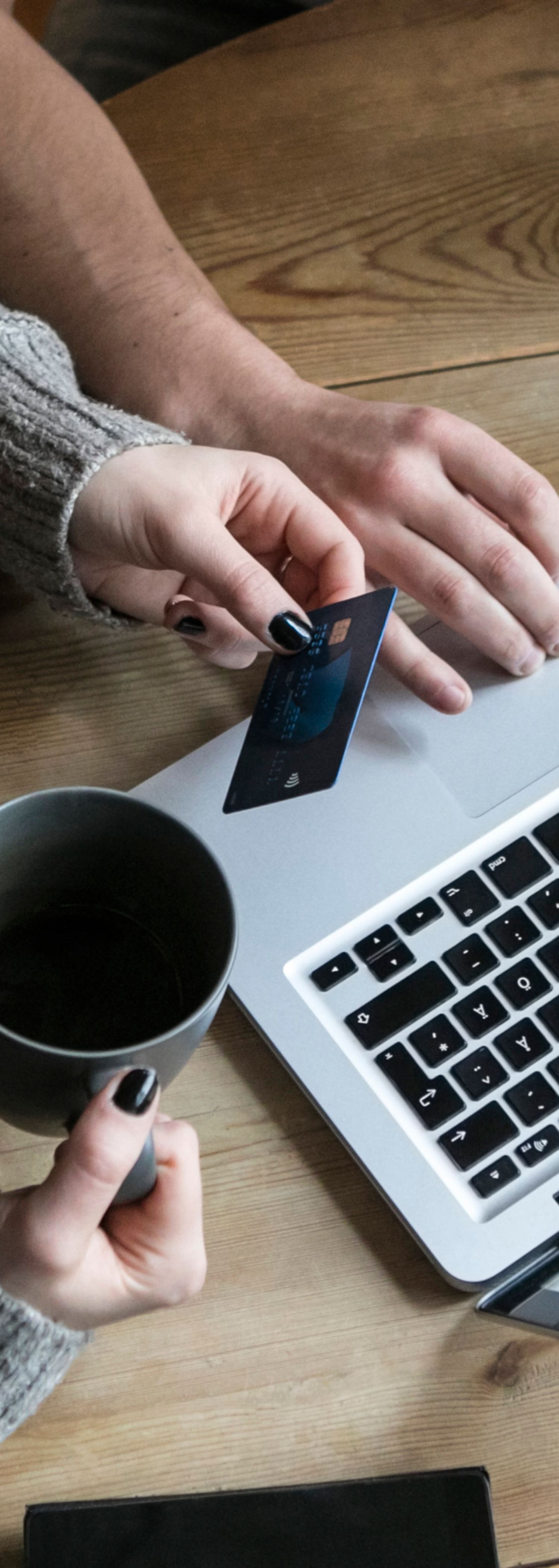 Couple pay by card on a computer