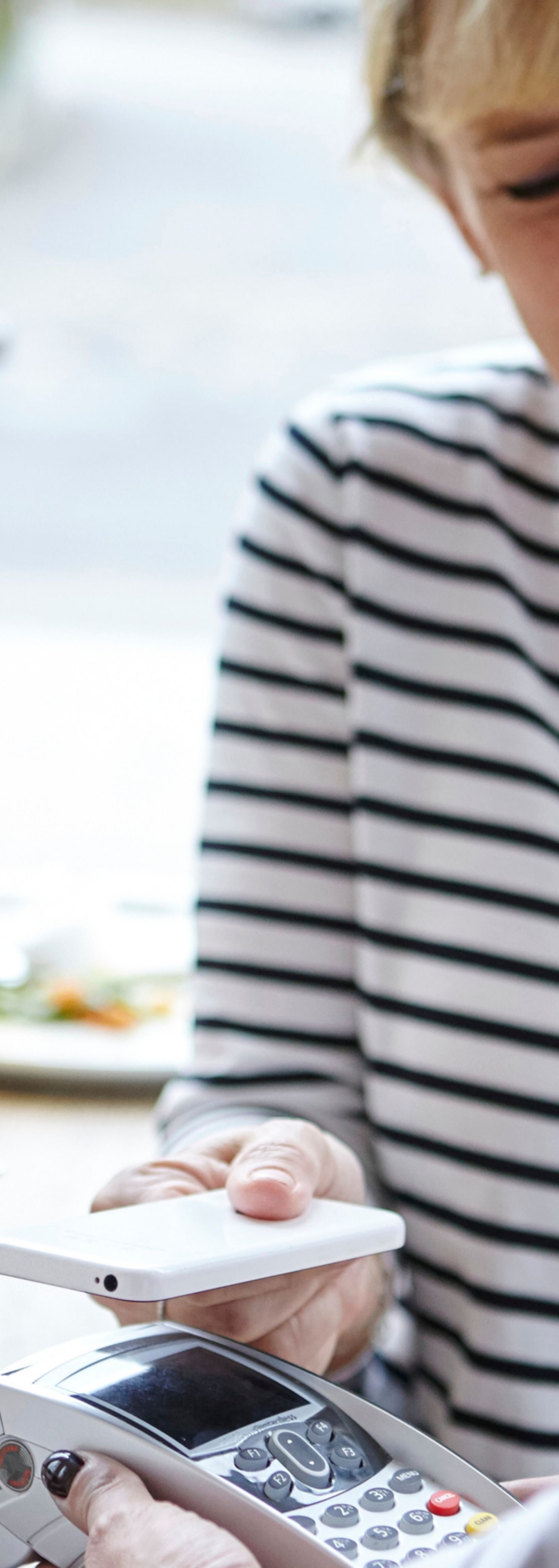 Kvinne betaler med mobiltelefon