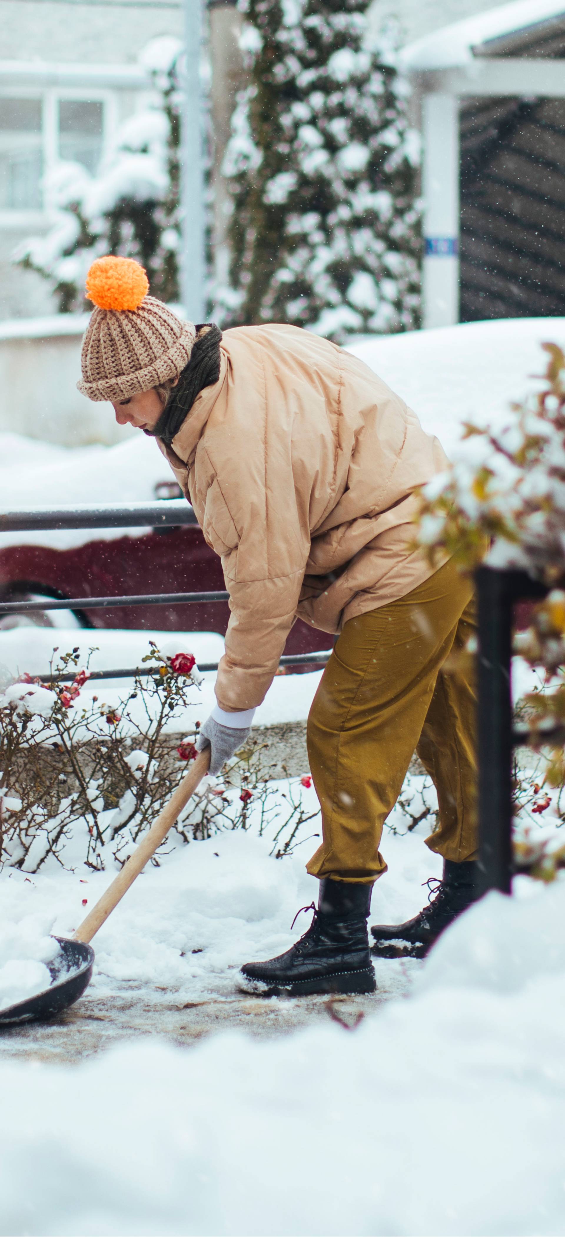 Woman shovelling snow