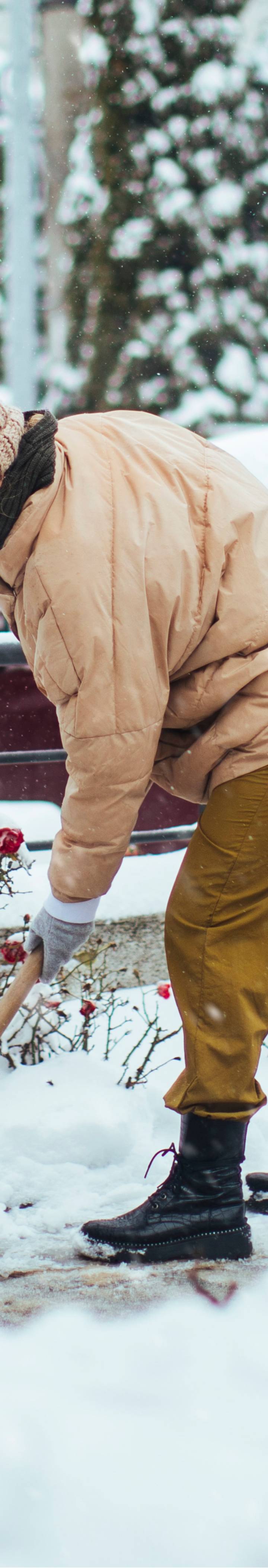 Woman shovelling snow