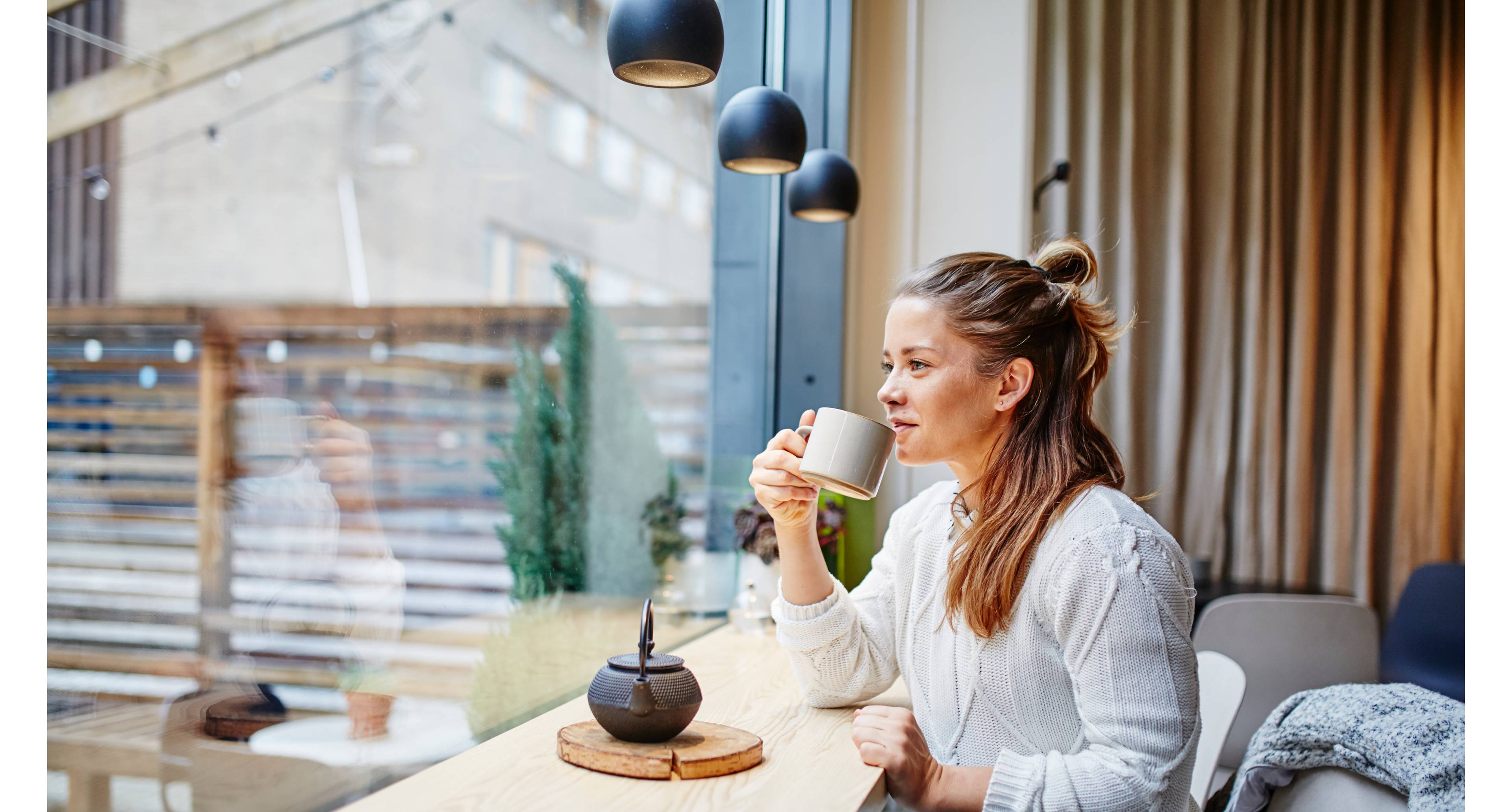 Ung kvinne drikker te på cafe PRISER