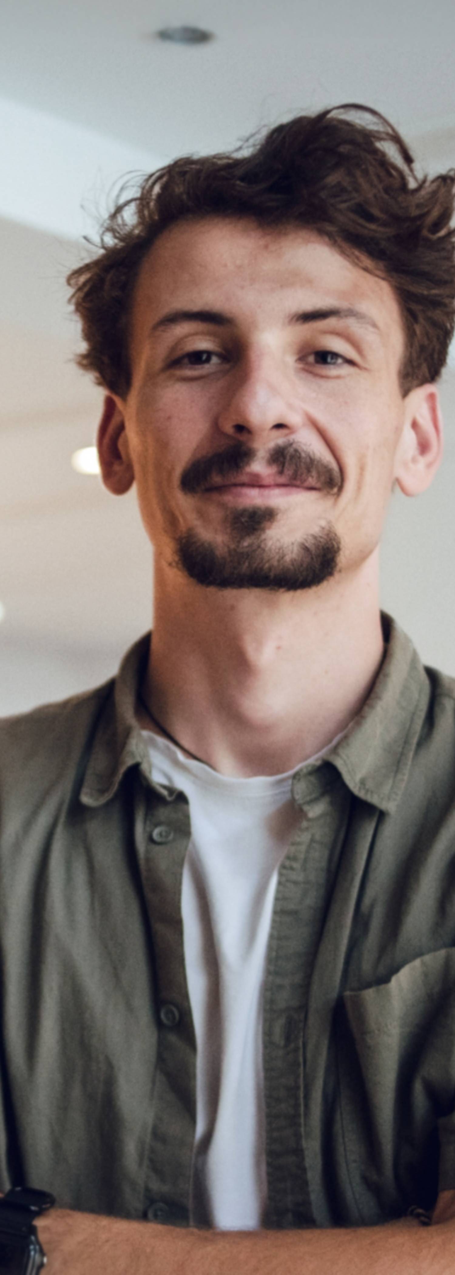Man with shirt smiling and looking into the camera. Has started a limited company